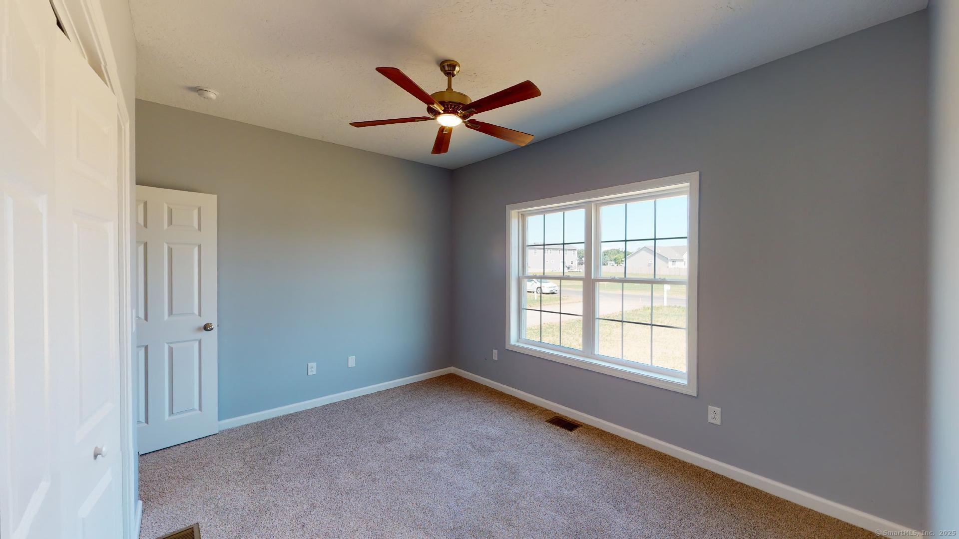 318 Capen Street Windsor, CT 06095 - Photo 29 of 37 a view of a livingroom with a ceiling fan and window