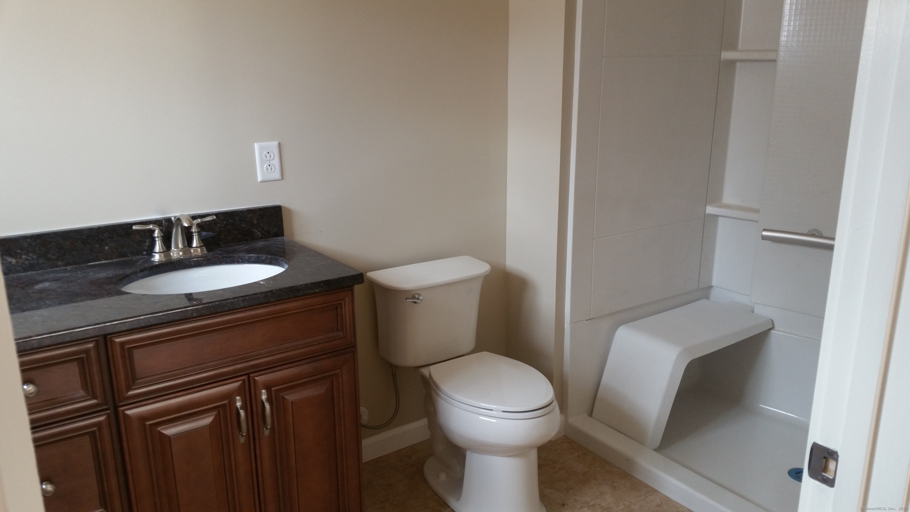 318 Capen Street Windsor, CT 06095 - Photo 33 of 37 a white toilet sitting next to a bathroom sink