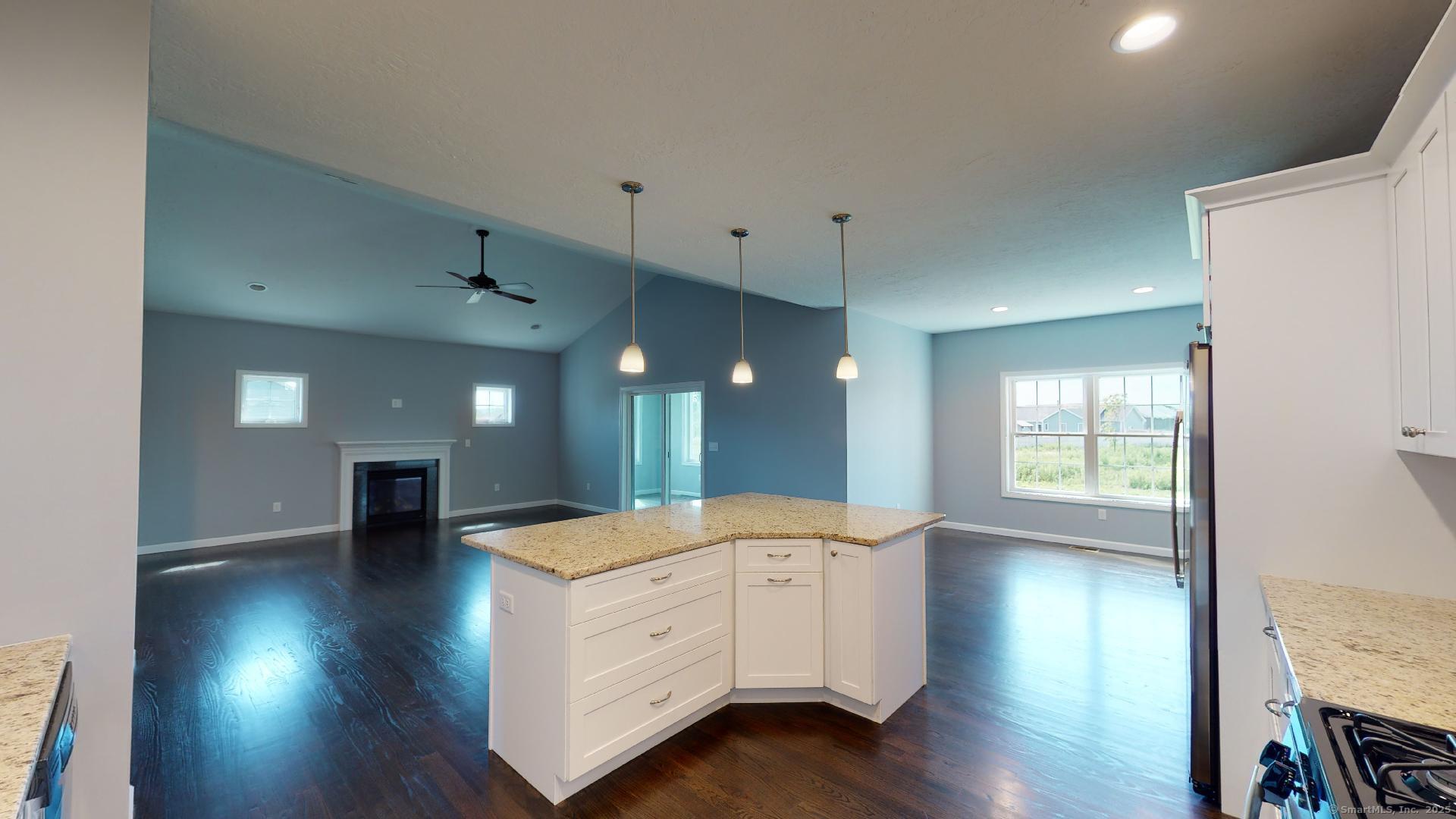 318 Capen Street Windsor, CT 06095 - Photo 7 of 37 a open kitchen with white cabinets and wooden floor