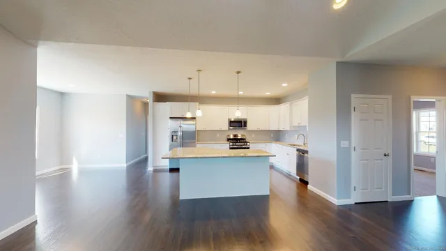 a view of kitchen with wooden floor and electronic appliances