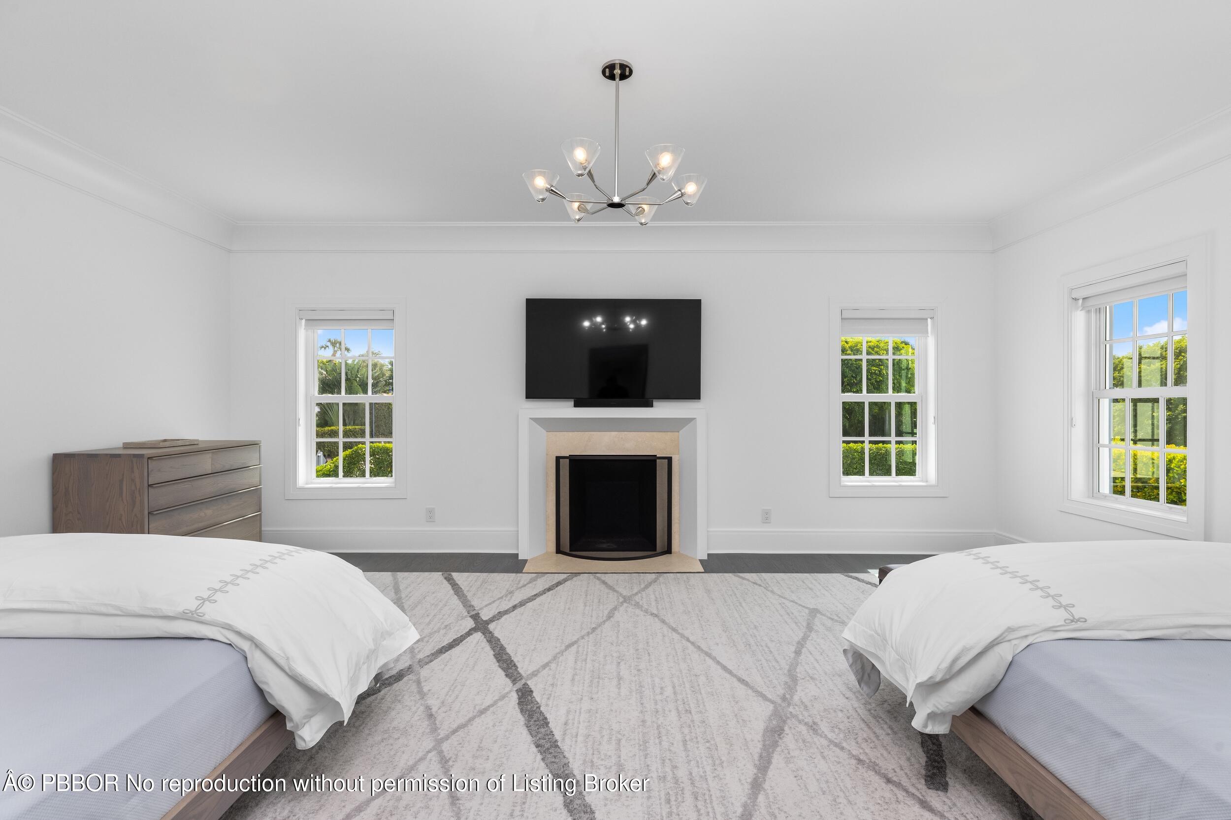 201 Banyan Road Palm Beach, FL 33480 - Photo 26 of 42 a bedroom with a large bed and a fireplace