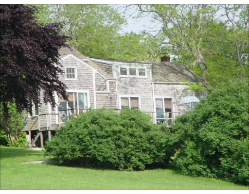 1935 Main Road Westport, MA 02791 - Photo 3 of 9 a view of a white house next to a yard with large trees