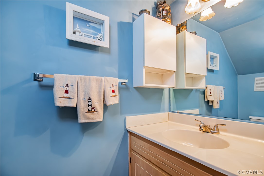 5501 Chestnut Bluff Road Midlothian, VA 23112 - Photo 15 of 33 a bathroom with a sink and a large mirror