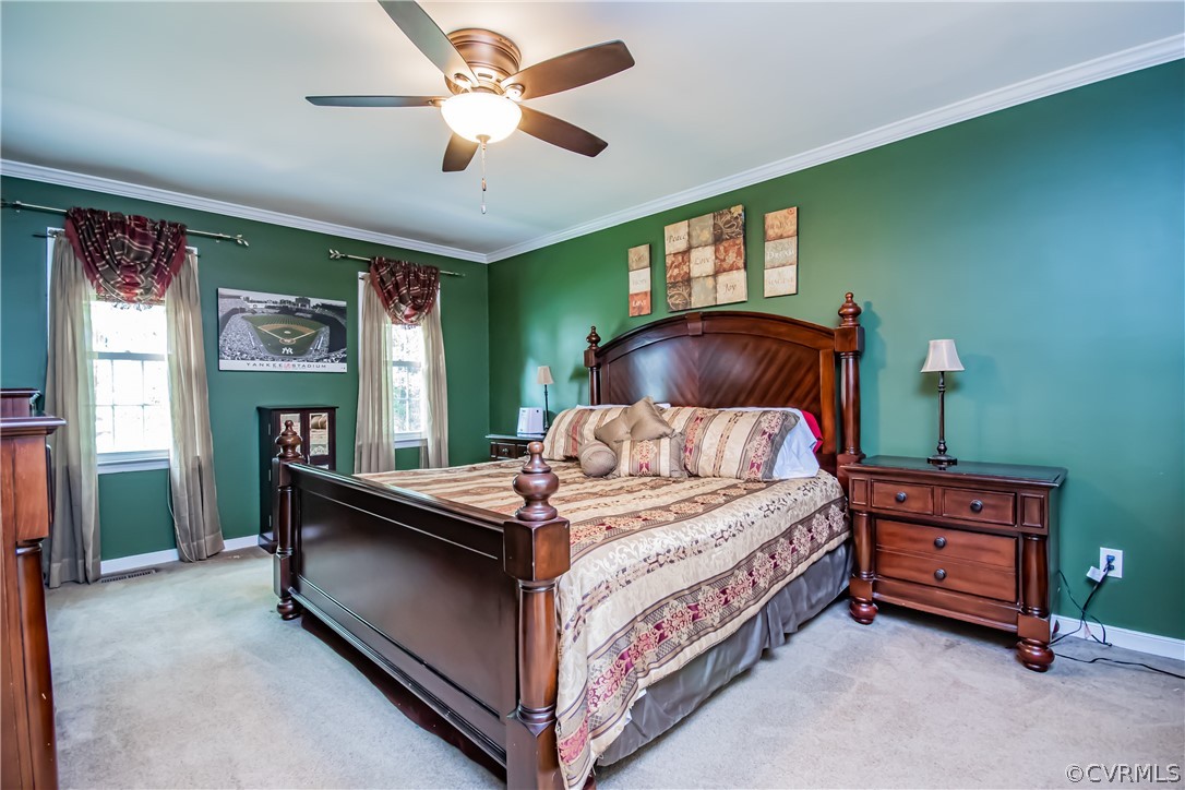 5501 Chestnut Bluff Road Midlothian, VA 23112 - Photo 16 of 33 a bed room with a bed and a chandelier