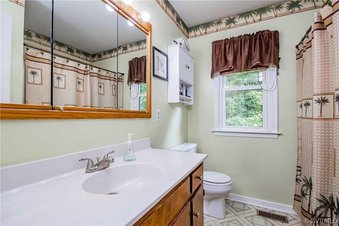 5501 Chestnut Bluff Road Midlothian, VA 23112 - Photo 19 of 33 a bathroom with a sink a toilet and shower curtain