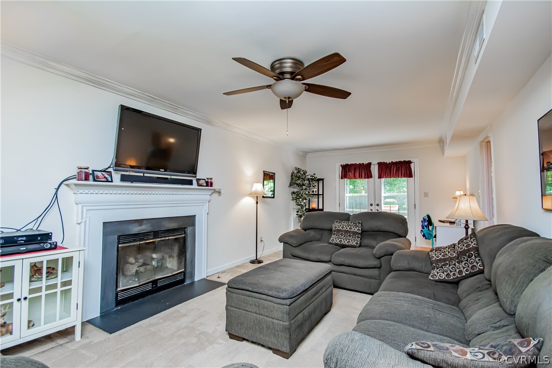 5501 Chestnut Bluff Road Midlothian, VA 23112 - Photo 6 of 33 a living room with furniture a fireplace and a flat screen tv