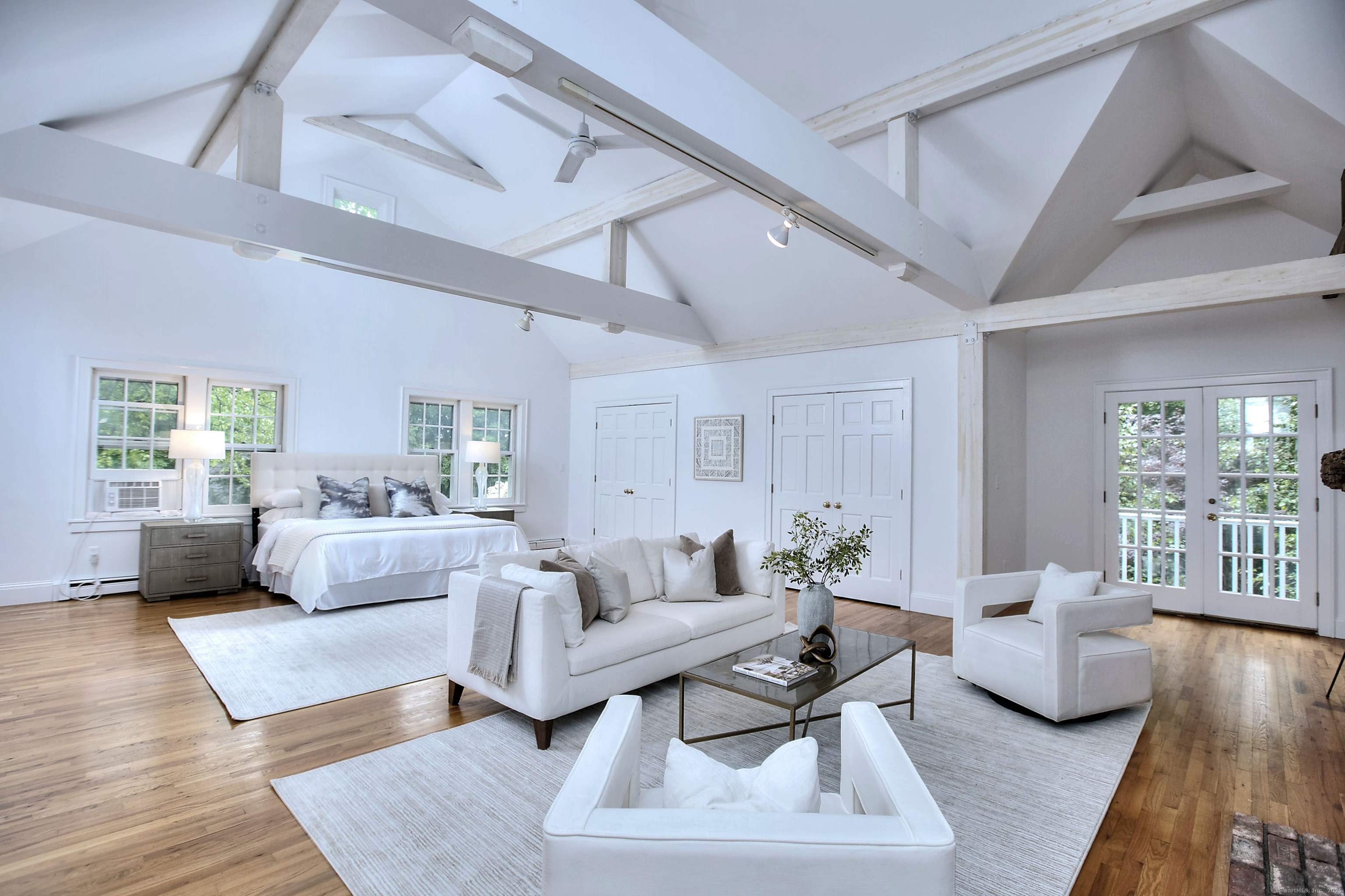 a living room with furniture and a wooden floor