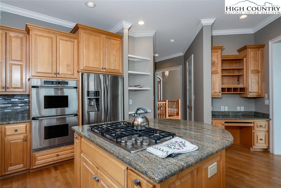 175 Boone Ridge Lane Boone, NC 28607 - Photo 23 of 47 a kitchen with kitchen island granite countertop a stove and a refrigerator