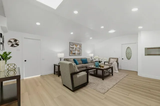 a living room with furniture and wooden floor