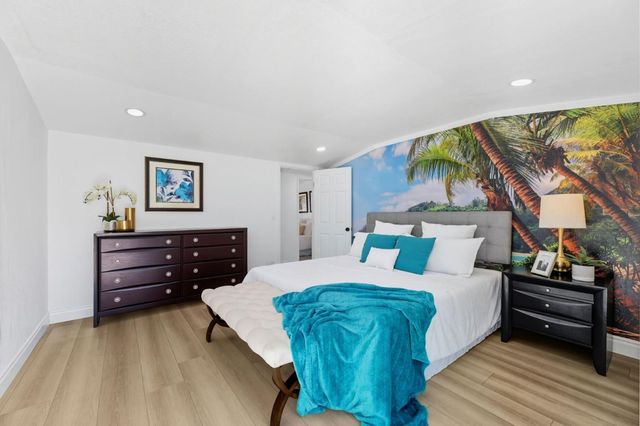 a bedroom with a bed and a lamp on table