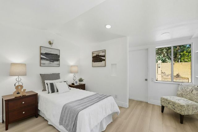 a bedroom with a bed and a lamp