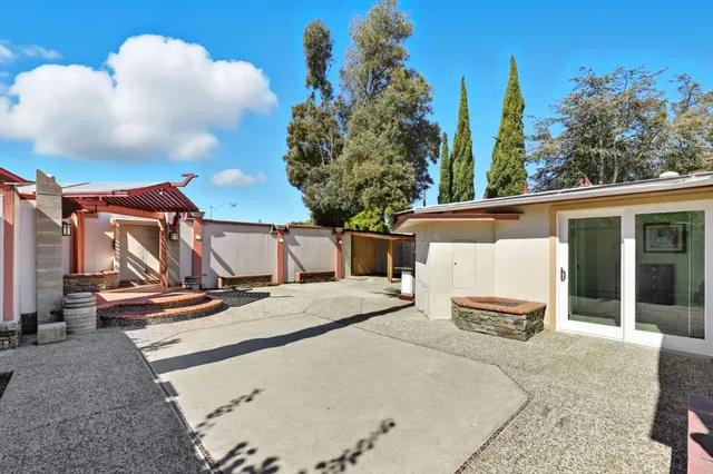 a patio with a table and chairs