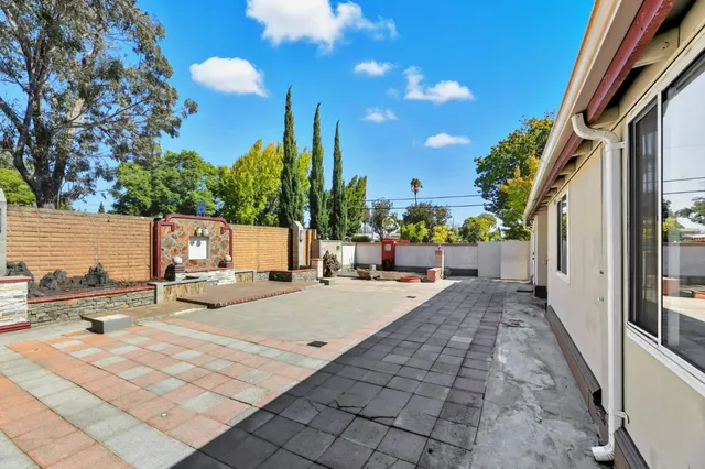 a backyard of a house with seating space and trees
