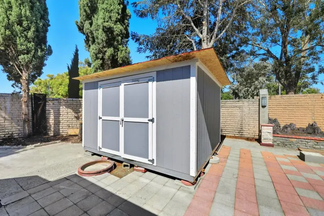 a view of a house with backyard and sitting area