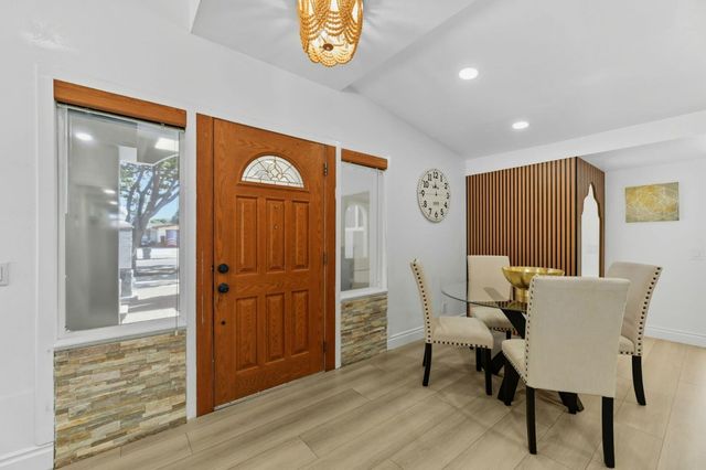 a kitchen with kitchen island a stove a sink and a refrigerator