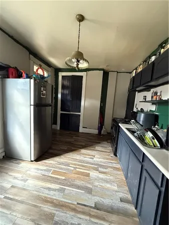 a kitchen with stainless steel appliances granite countertop a refrigerator and a stove top oven