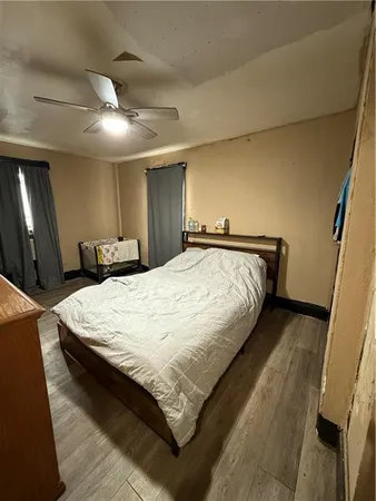 a bed sitting in a bedroom and a mirror