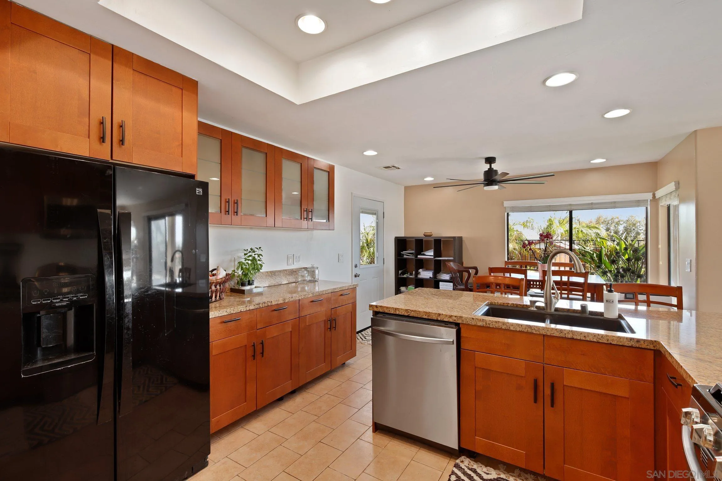 5080 Frazee Road Oceanside, CA 92057 - Photo 13 of 44 a kitchen with stove a sink and cabinets
