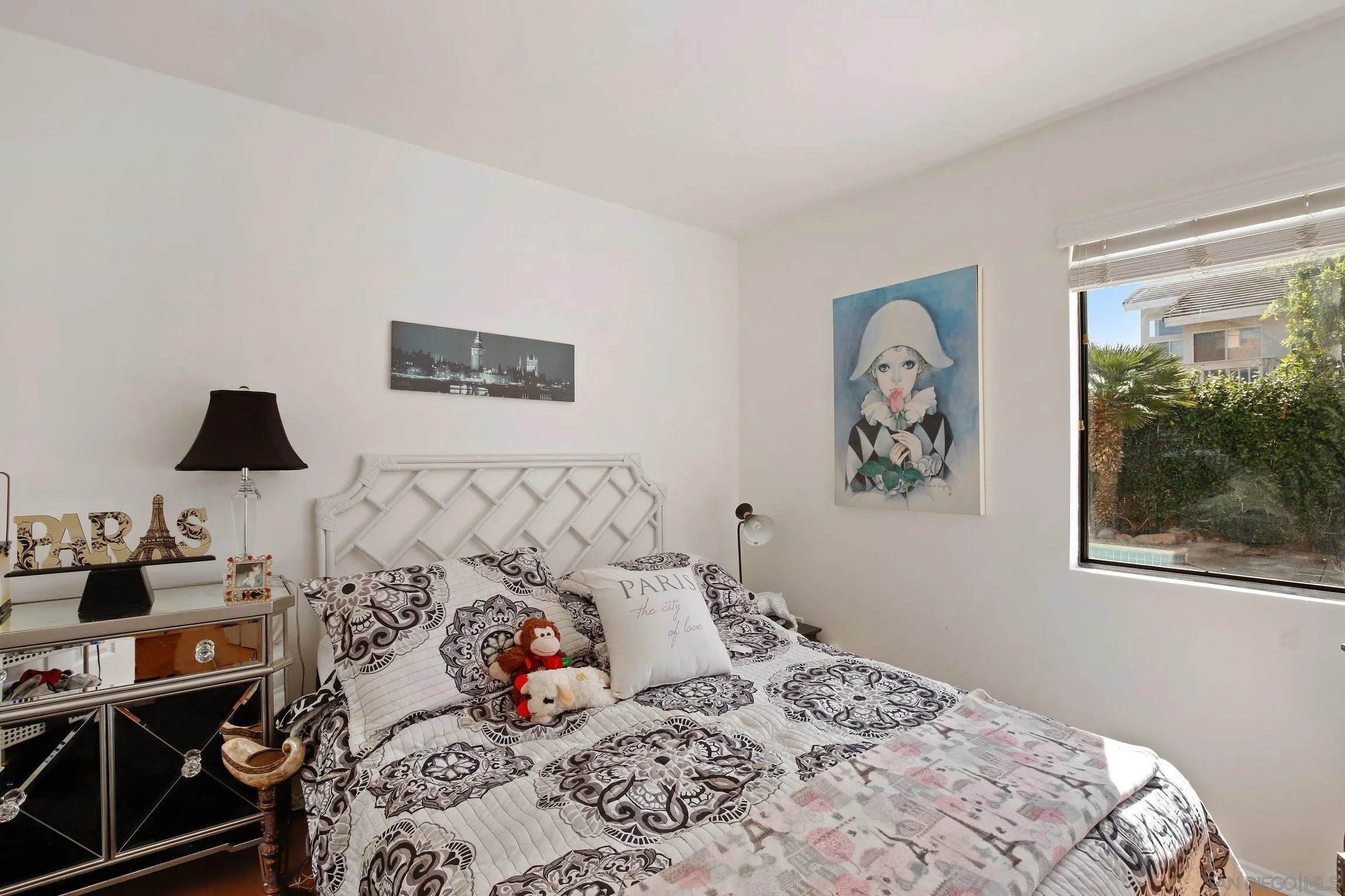 5080 Frazee Road Oceanside, CA 92057 - Photo 14 of 44 a bedroom with a bed and a lamp on dresser