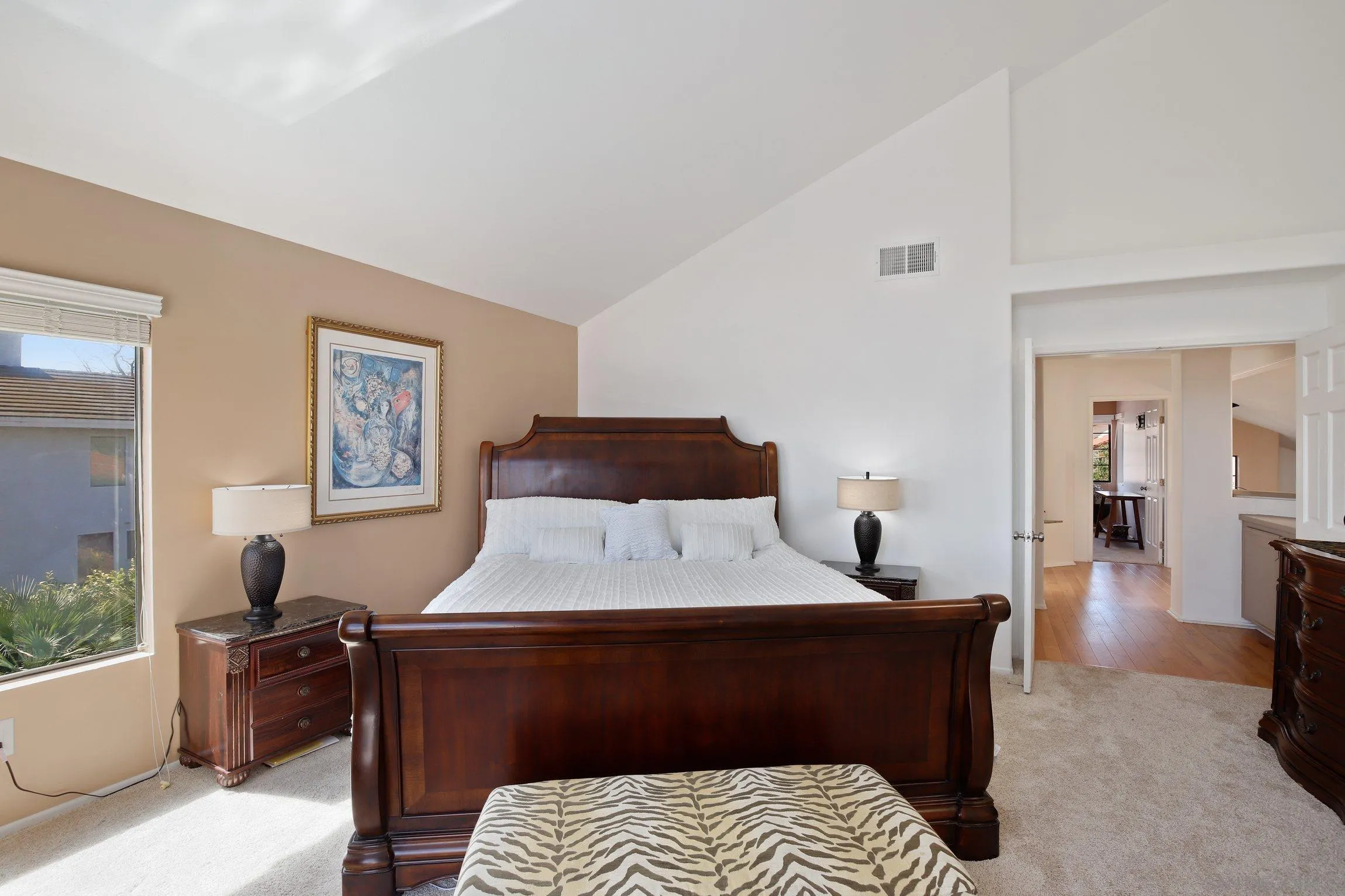 5080 Frazee Road Oceanside, CA 92057 - Photo 16 of 44 a bedroom with a bed and wooden floor