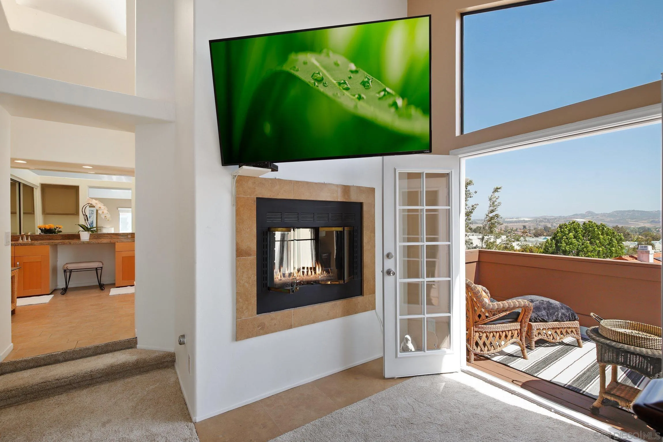 5080 Frazee Road Oceanside, CA 92057 - Photo 17 of 44 a living room with a fireplace and a flat screen tv