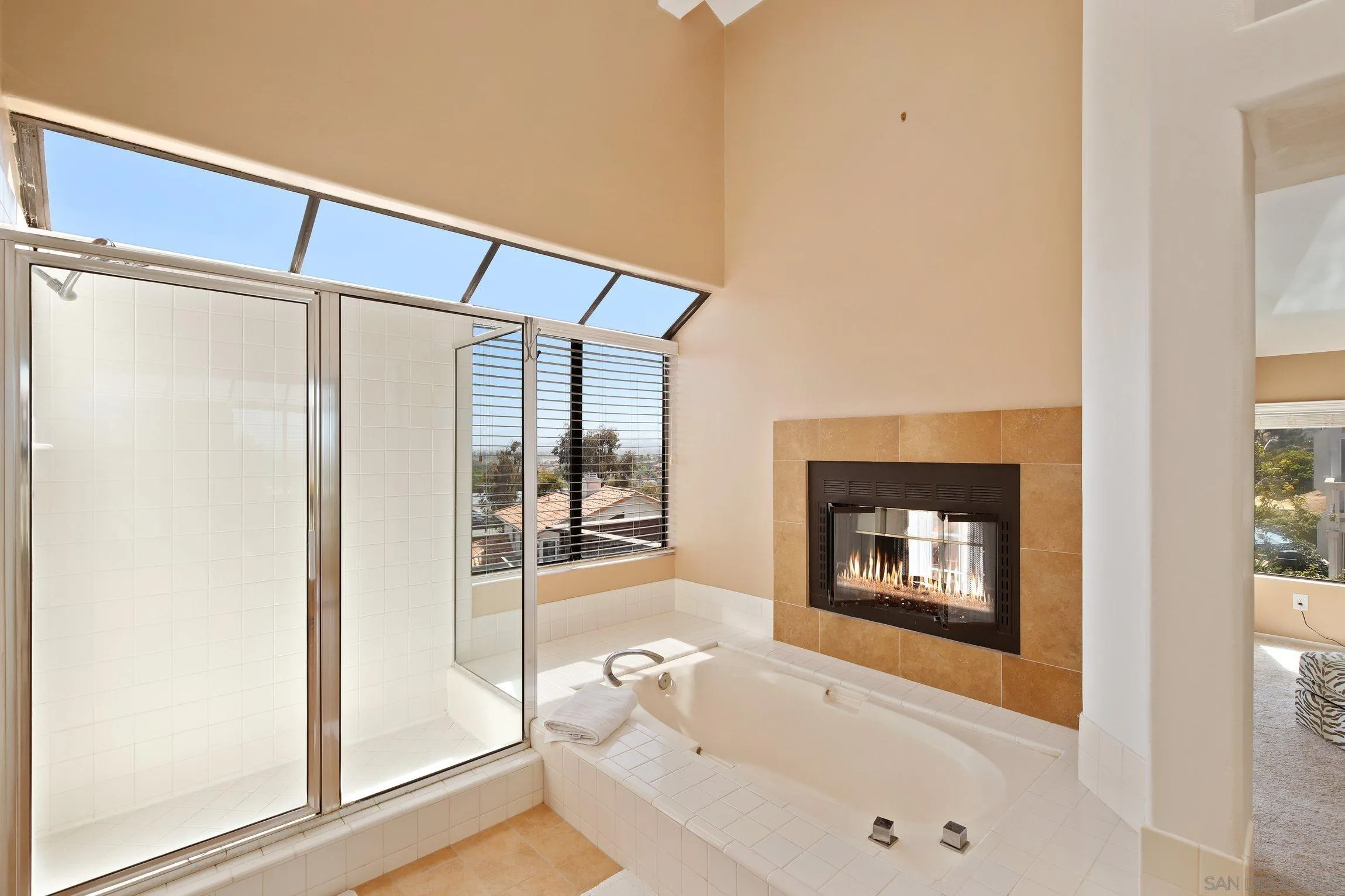 5080 Frazee Road Oceanside, CA 92057 - Photo 21 of 44 a bathroom with a bathtub and a shower