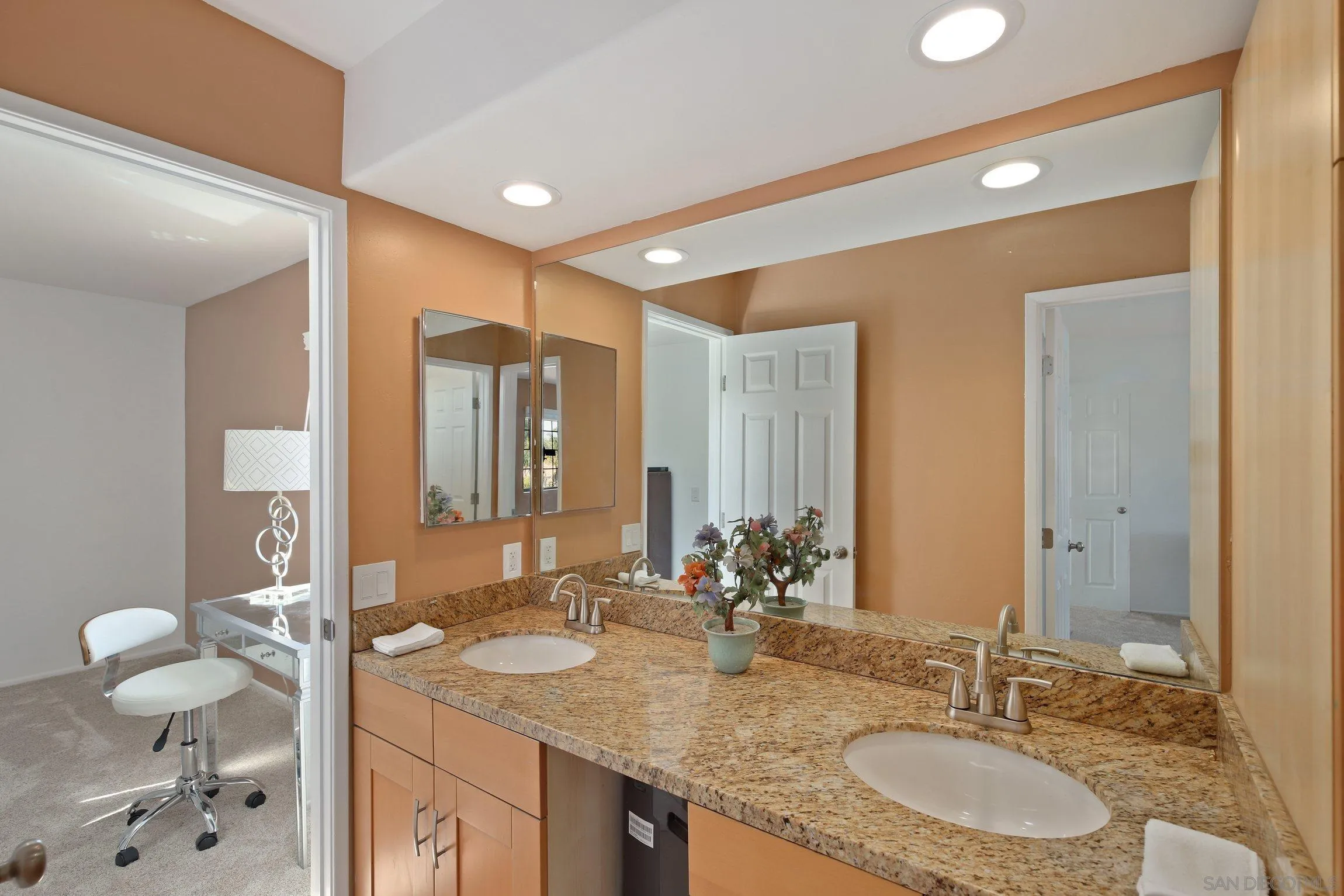 5080 Frazee Road Oceanside, CA 92057 - Photo 24 of 44 a bathroom with a granite countertop sink and a mirror