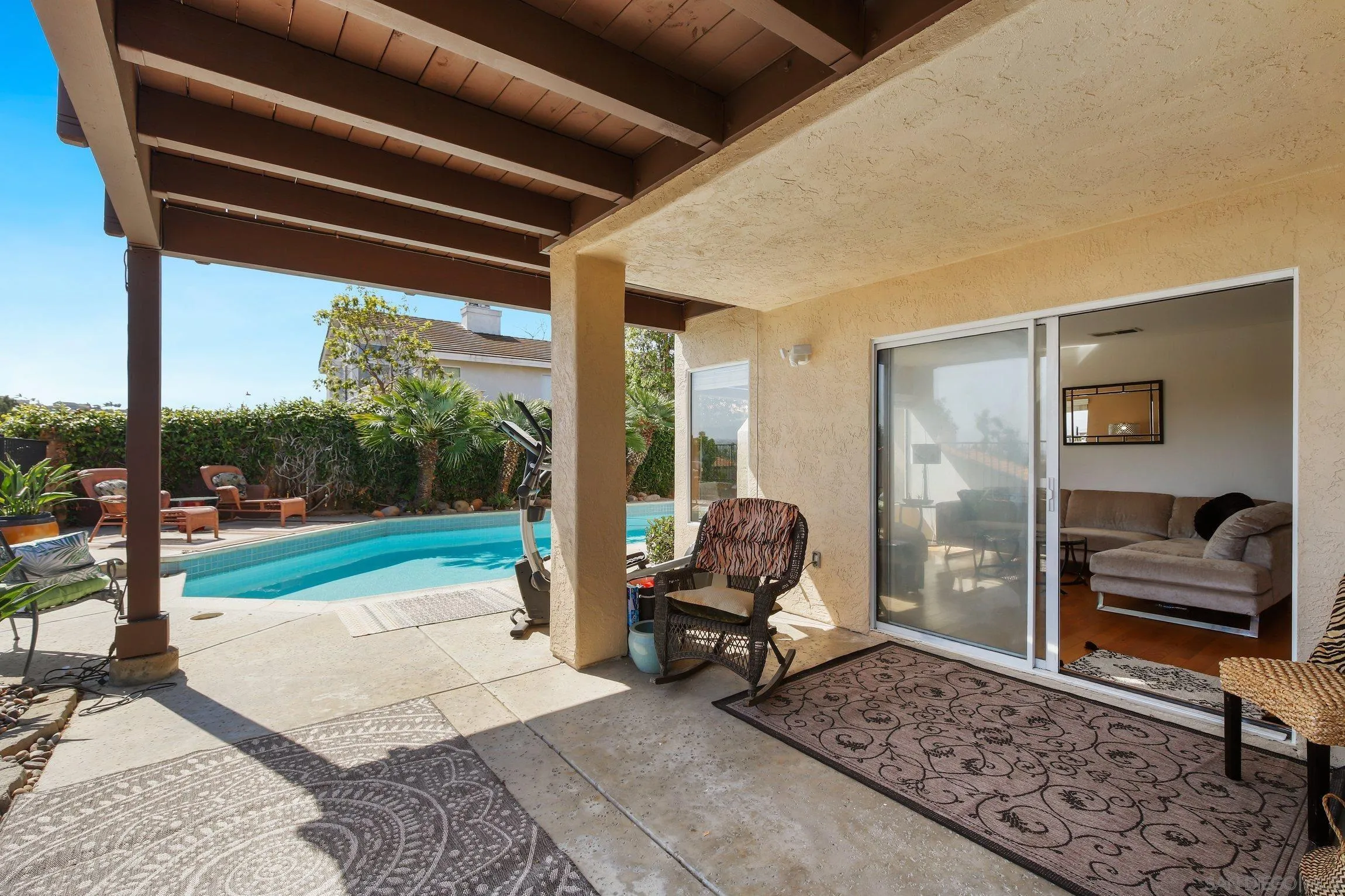 5080 Frazee Road Oceanside, CA 92057 - Photo 27 of 44 a living room with furniture and a floor to ceiling window