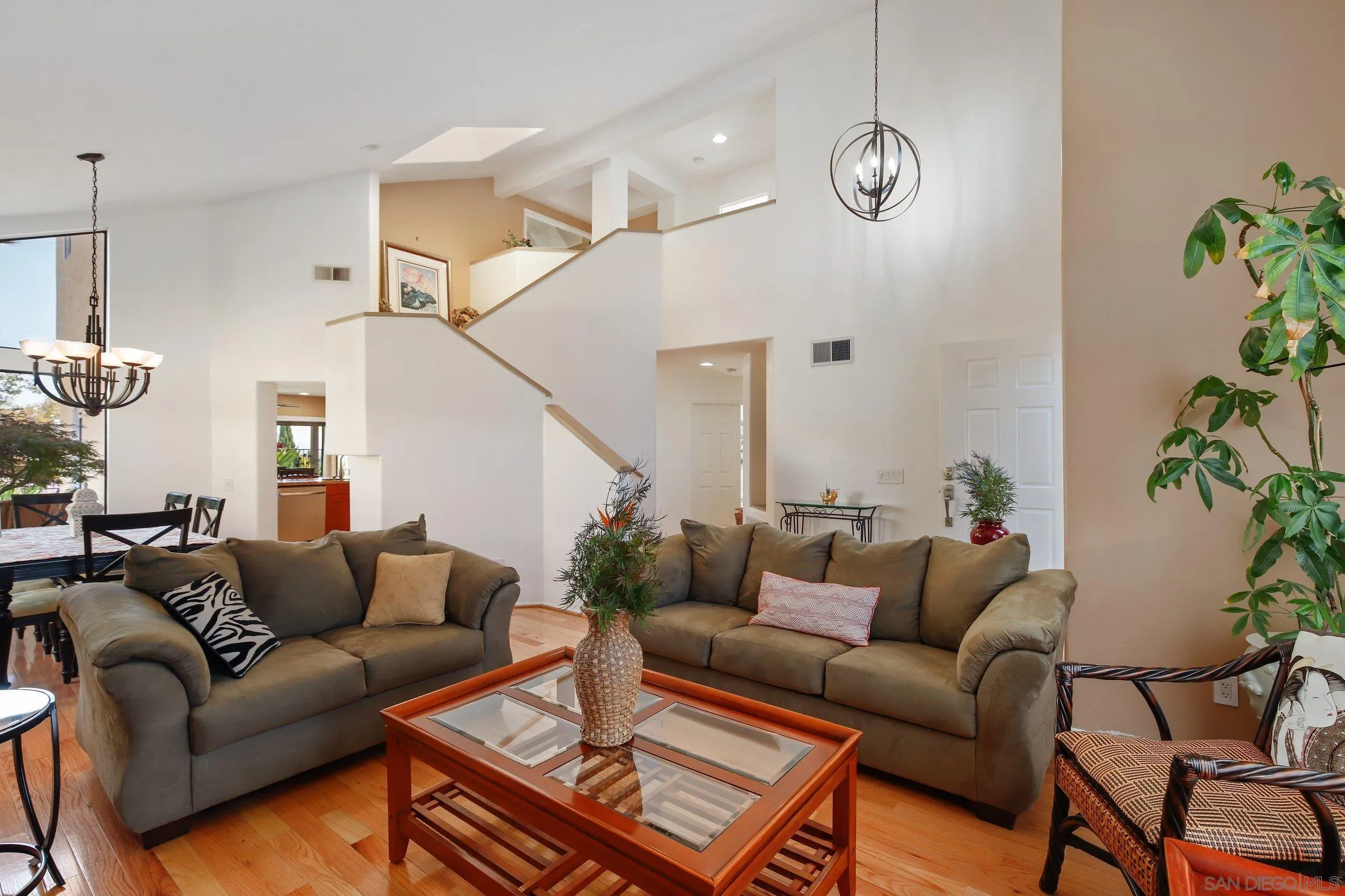 5080 Frazee Road Oceanside, CA 92057 - Photo 7 of 44 a living room with furniture and wooden floor