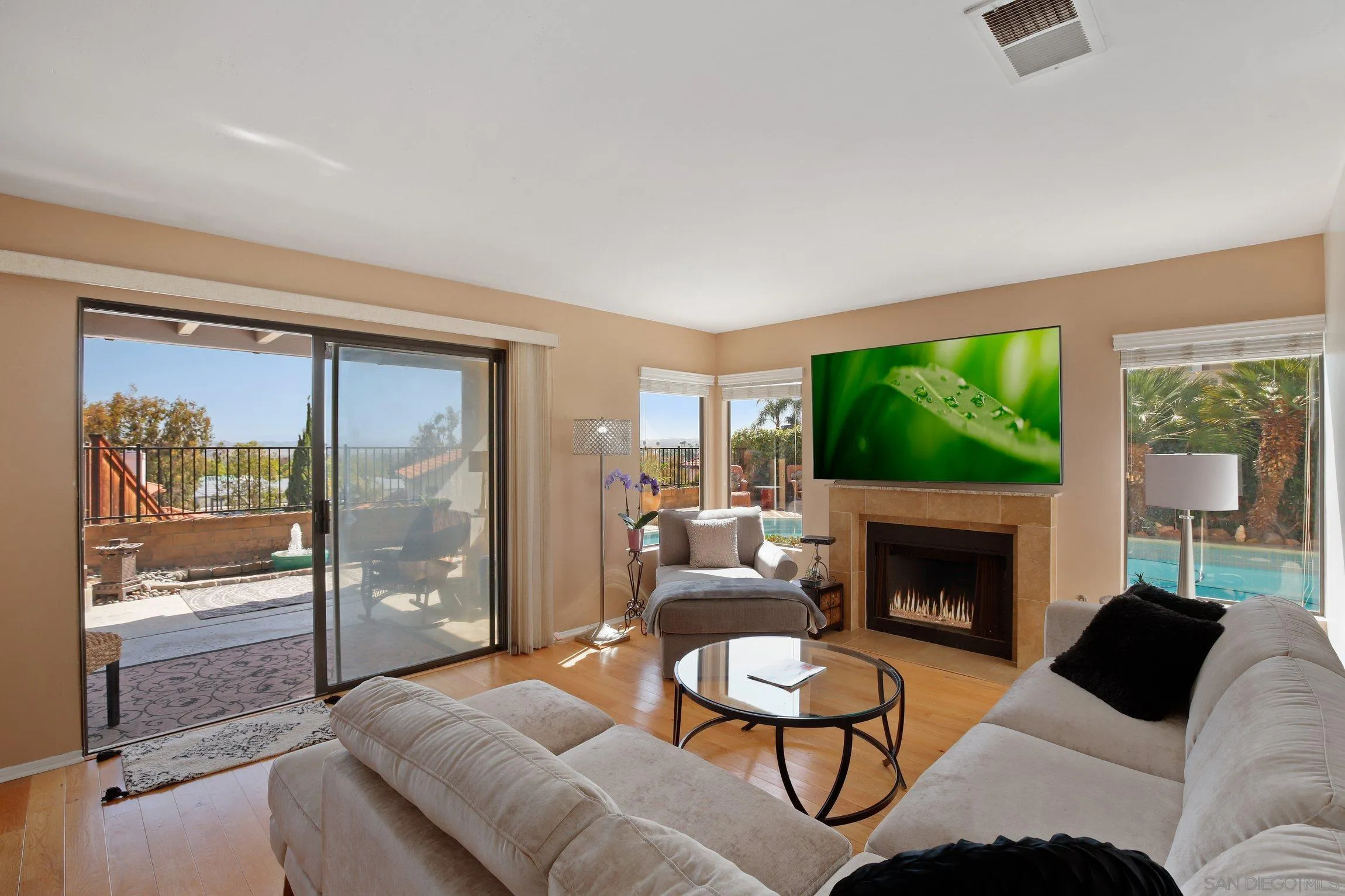 5080 Frazee Road Oceanside, CA 92057 - Photo 9 of 44 a living room with furniture a floor to ceiling window and a fireplace