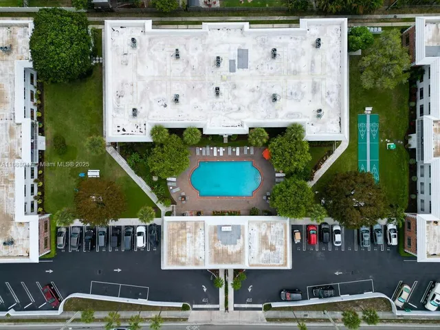 an aerial view of residential houses with outdoor space and parking