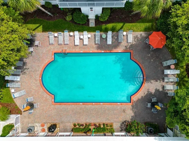 an aerial view of a house with swimming pool and garden