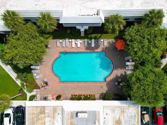 an aerial view of a house with swimming pool and garden
