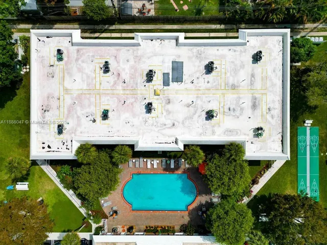 an aerial view of residential house with outdoor space and swimming pool