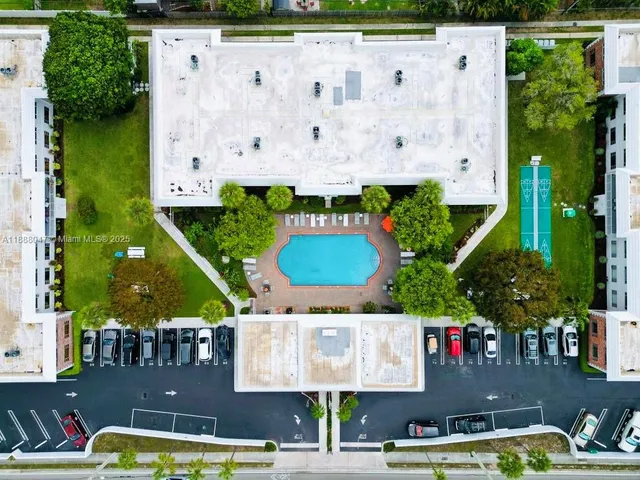 an aerial view of swimming pool with outdoor seating