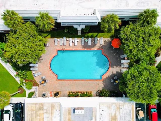 an aerial view of a house with outdoor space and swimming pool
