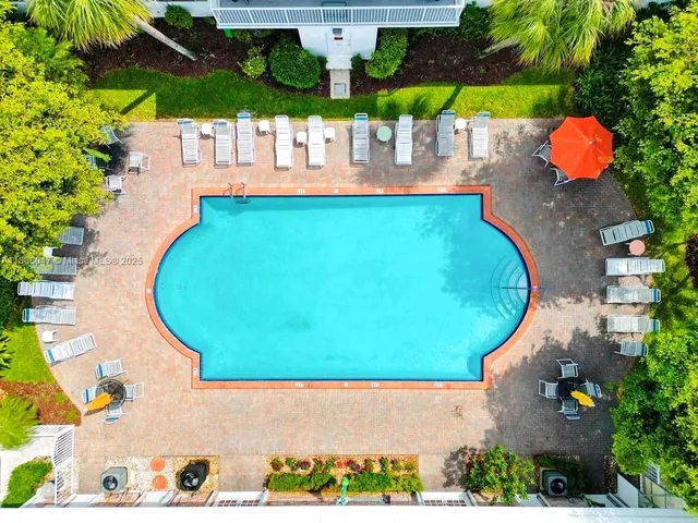 a view of a swimming pool with sitting area