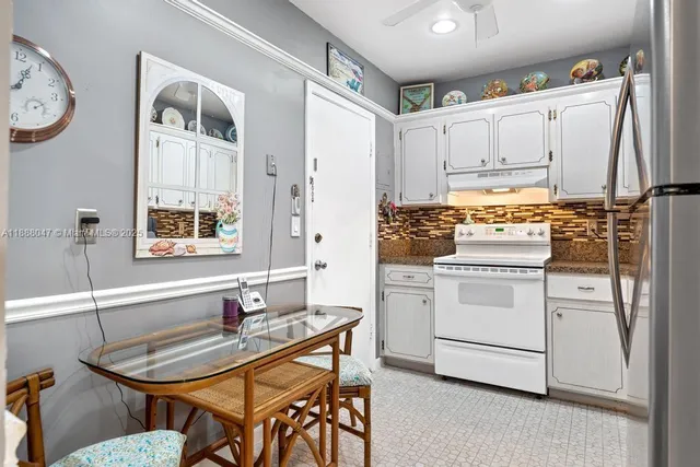 a kitchen with a stove a sink and a refrigerator