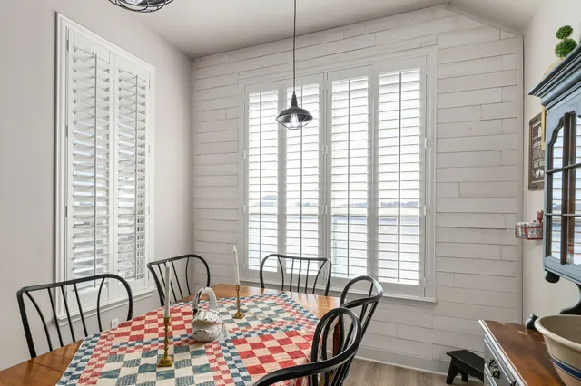 a view of a dining room with furniture and windows