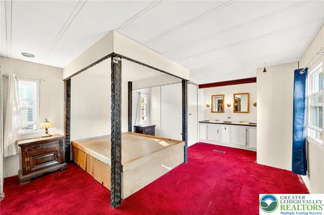 a bedroom with a bed and a view of kitchen