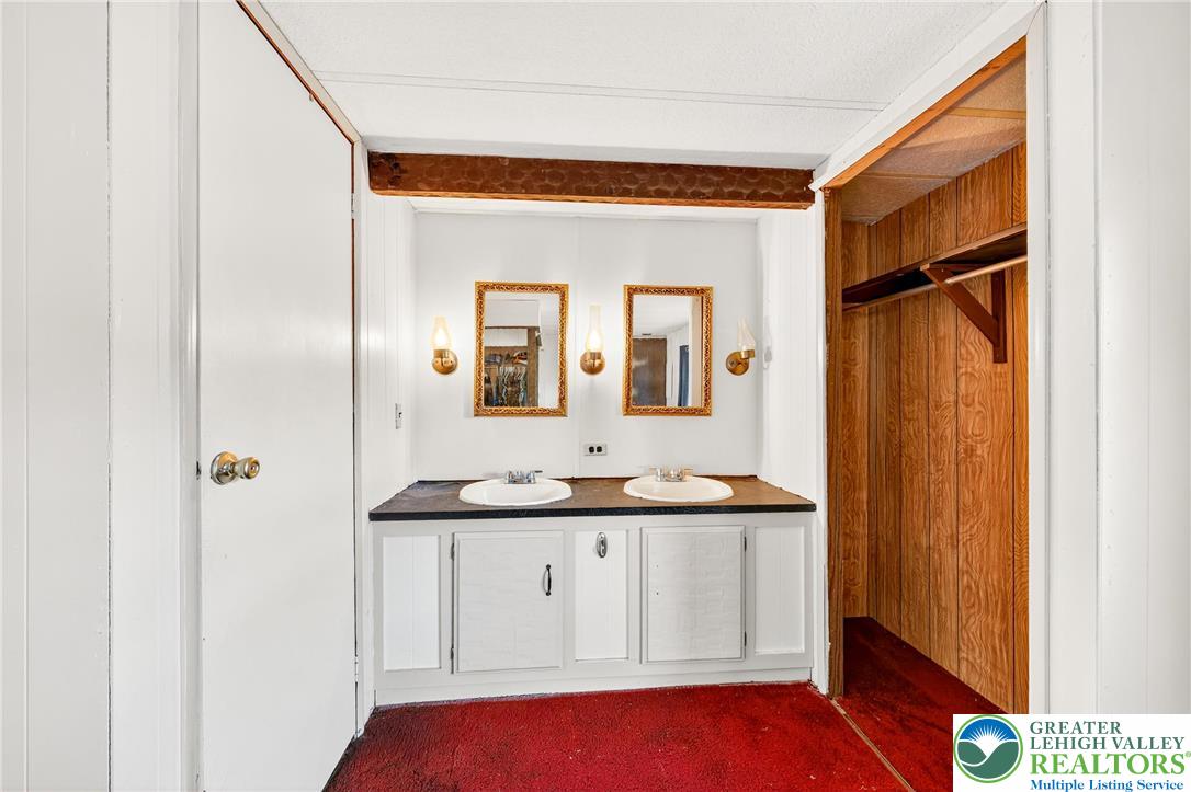 8220 Airport Road, Unit 4 Coatesville, PA 19320 - Photo 17 of 28 a bathroom with a sink and a mirror