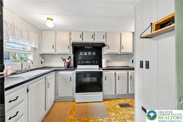 a kitchen with stainless steel appliances a stove a sink and a refrigerator