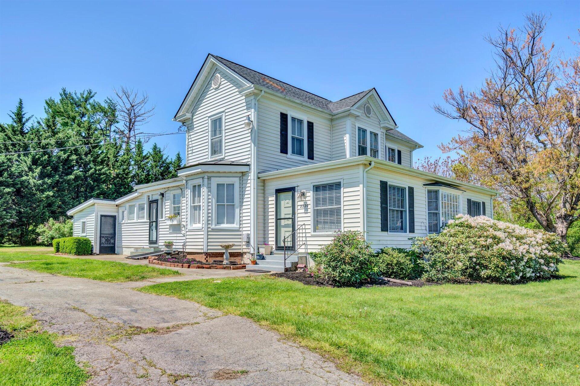 3840 Cove Road Roanoke, VA 24017 - Photo 1 of 47 a front view of a house with a yard and trees