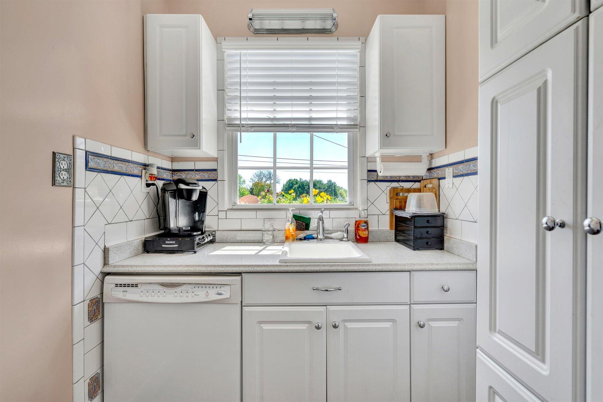 3840 Cove Road Roanoke, VA 24017 - Photo 14 of 47 a kitchen with a sink a window and cabinets