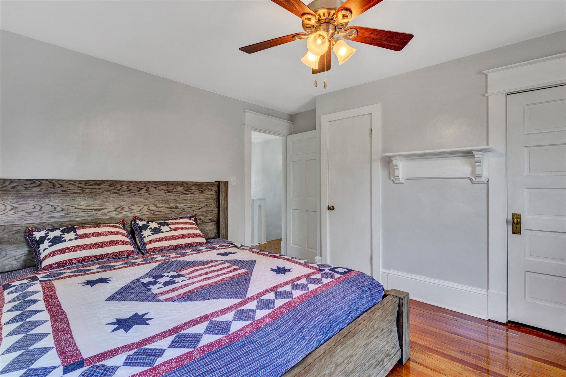 3840 Cove Road Roanoke, VA 24017 - Photo 25 of 47 a bedroom with a bed and a chandelier