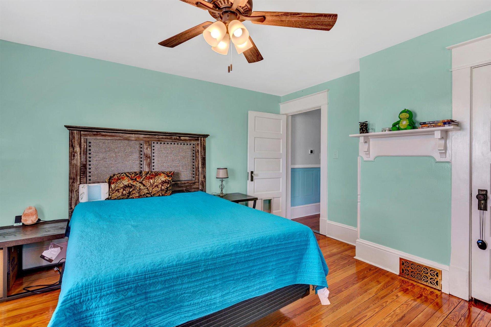3840 Cove Road Roanoke, VA 24017 - Photo 27 of 47 a bedroom with a bed and a chandelier