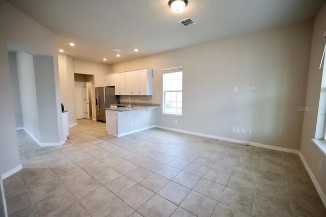 a kitchen with stainless steel appliances granite countertop a sink refrigerator and microwave