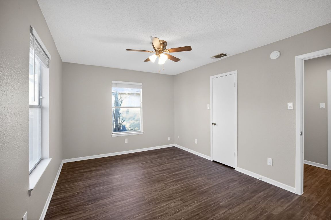 1505 Timber Street Georgetown, TX 78626 - Photo 11 of 22 Spare room featuring dark wood-style flooring, ceiling fan, and a textured ceiling