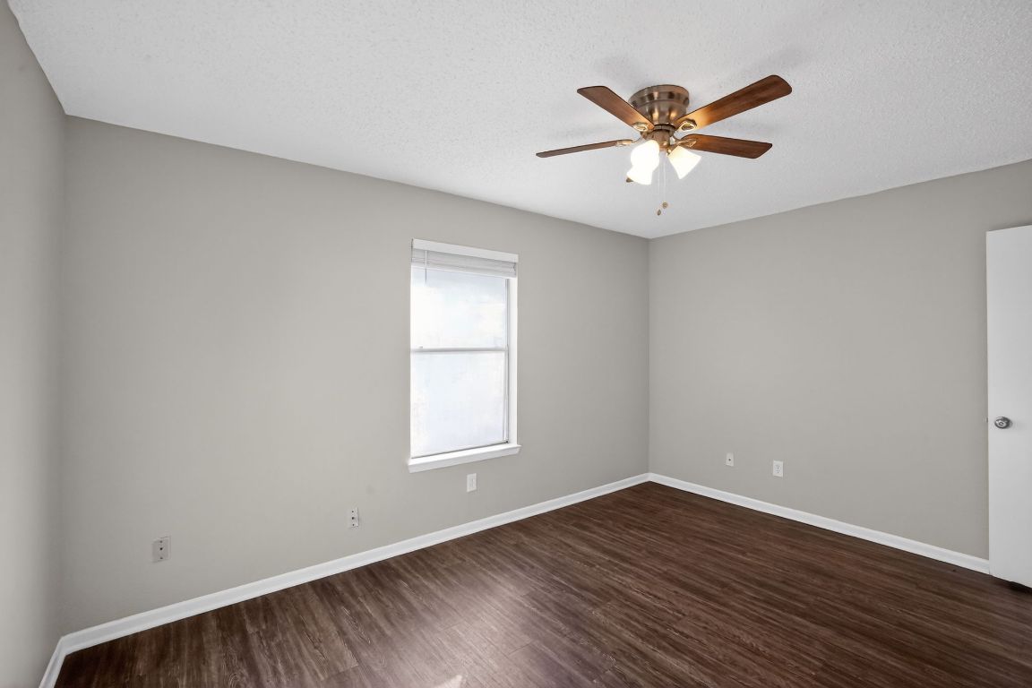 1505 Timber Street Georgetown, TX 78626 - Photo 3 of 22 Spare room with dark wood-style floors, a textured ceiling, and a ceiling fan