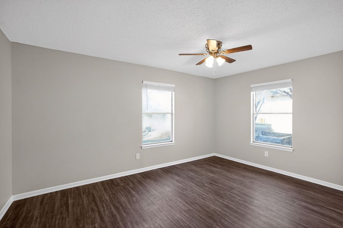 1505 Timber Street Georgetown, TX 78626 - Photo 4 of 22 Empty room featuring dark wood-style flooring, a textured ceiling, and ceiling fan